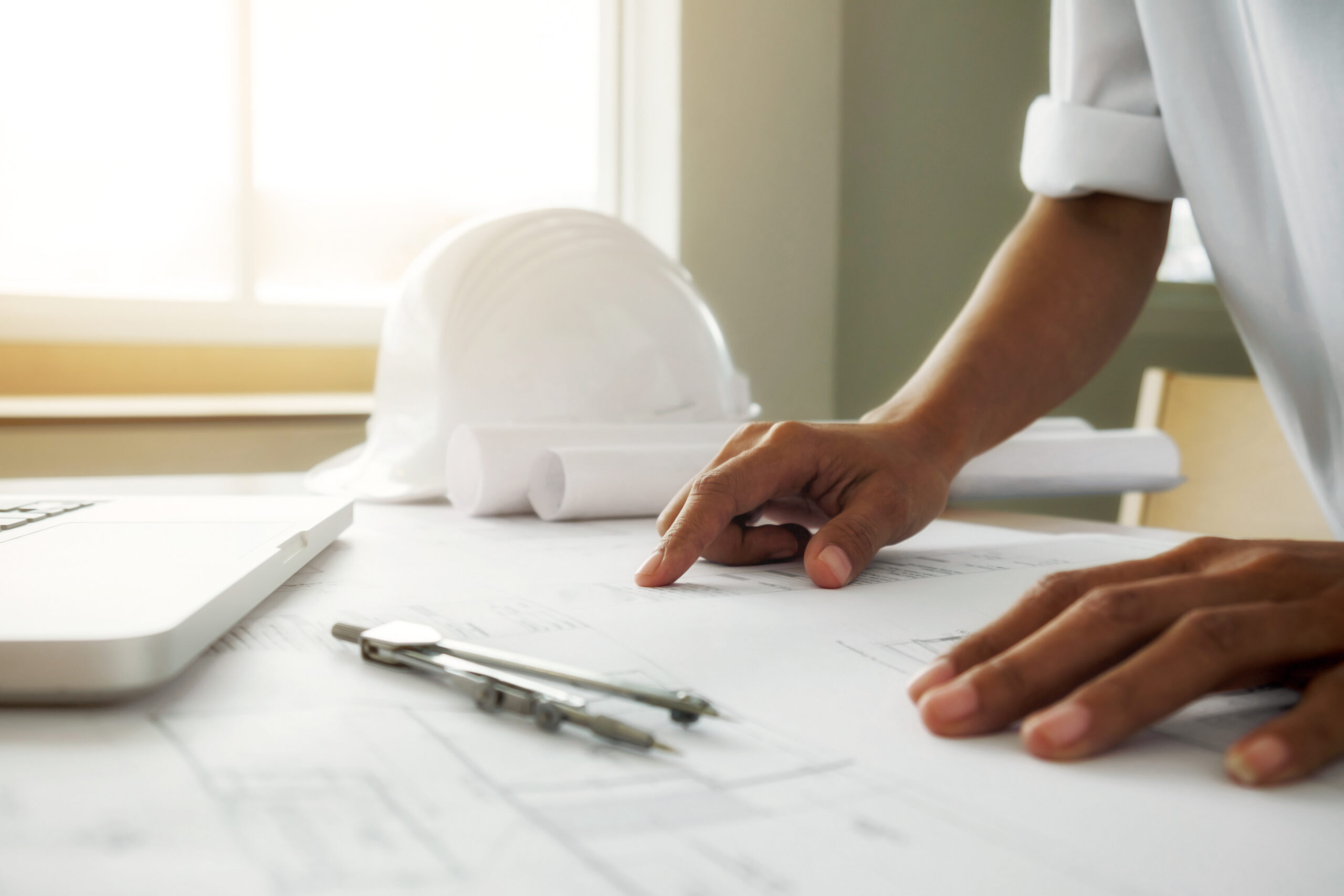 hands engineer working blueprint construction concept engineering tools vintage tone retro filter effect soft focus selective focus scaled.jpg
